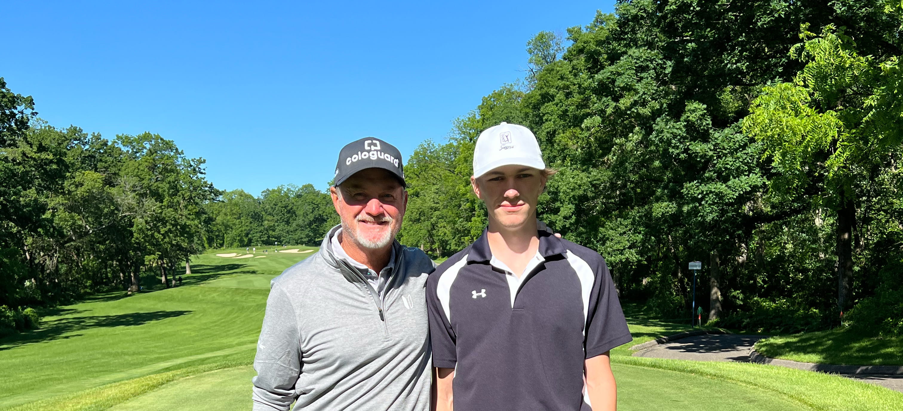 Pro golfer Jerry Kelly and young golfer at course