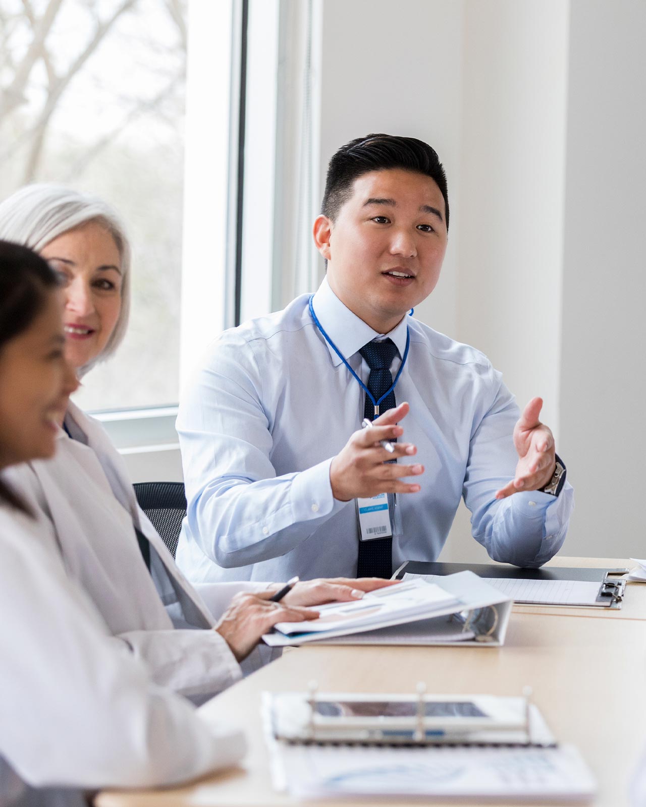 A team of doctors talking around a conference table.
