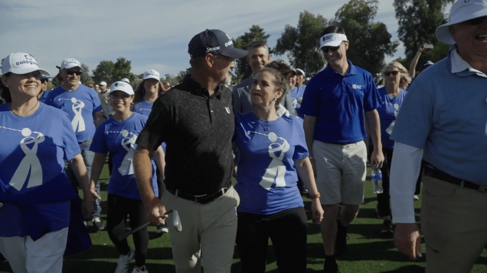 A group of people in blue shirts at a golf tournament